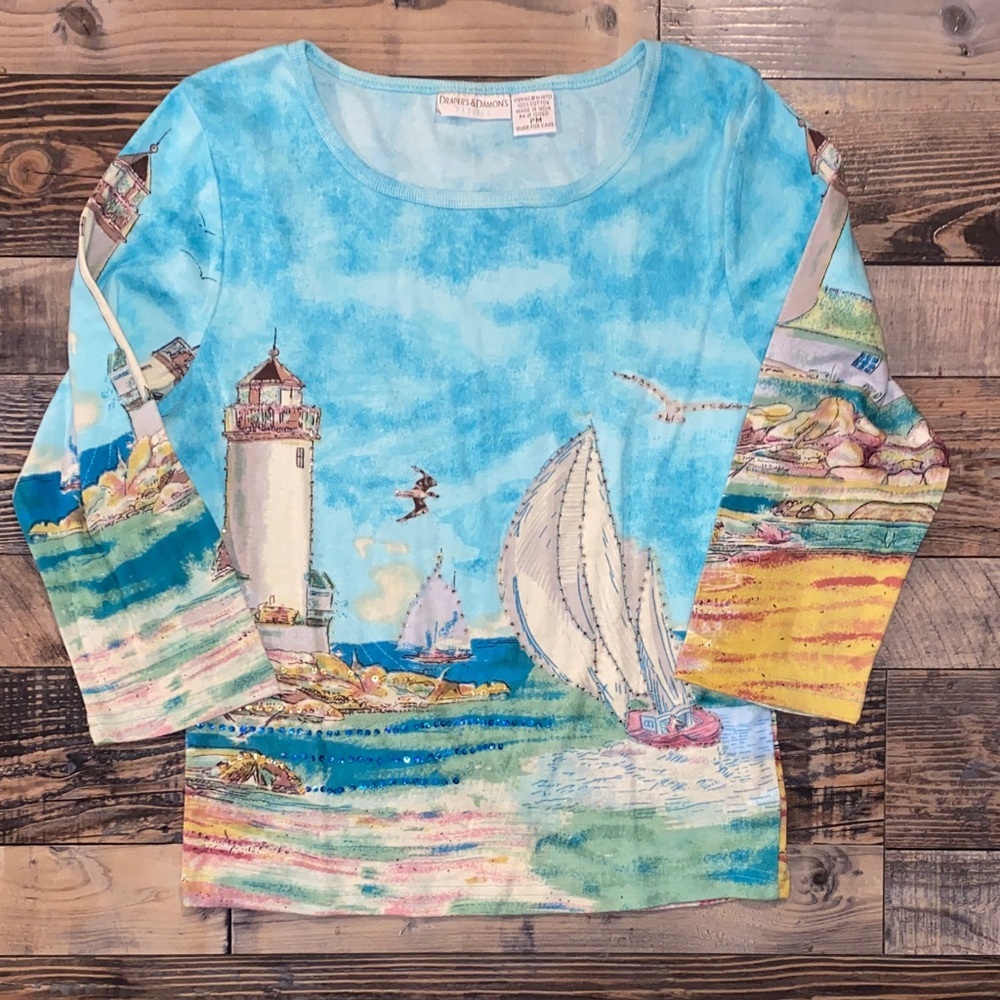 Vibrant Sequined Nautical Adventure blouse with sailboats and lighthouses.